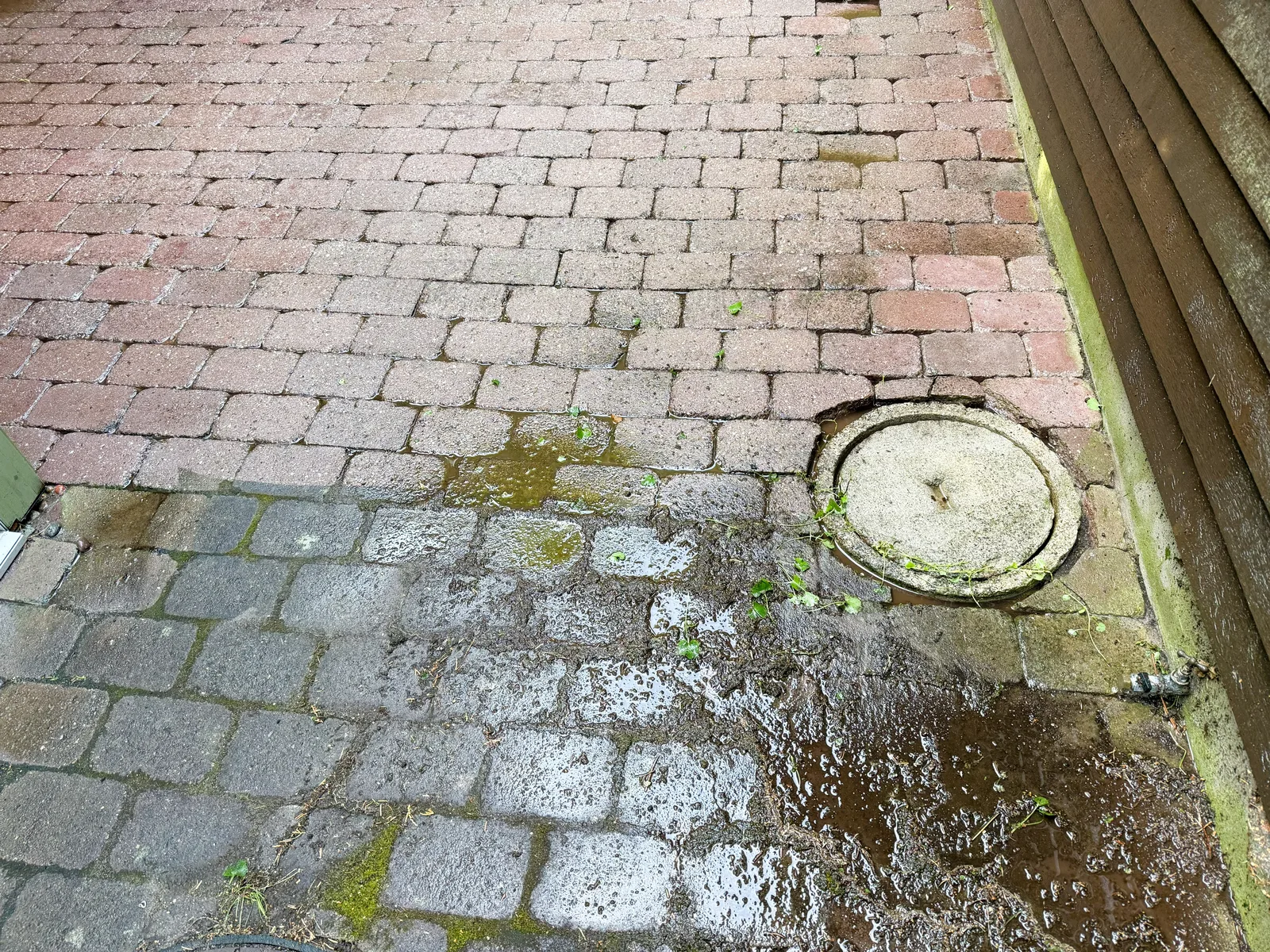 Technician pressure washing a commercial storefront exterior