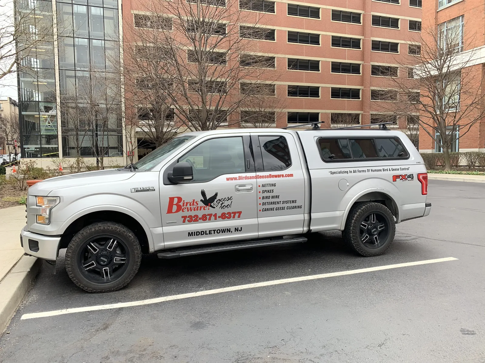 Birds & Geese Beware service truck on site for a bird deterrent install