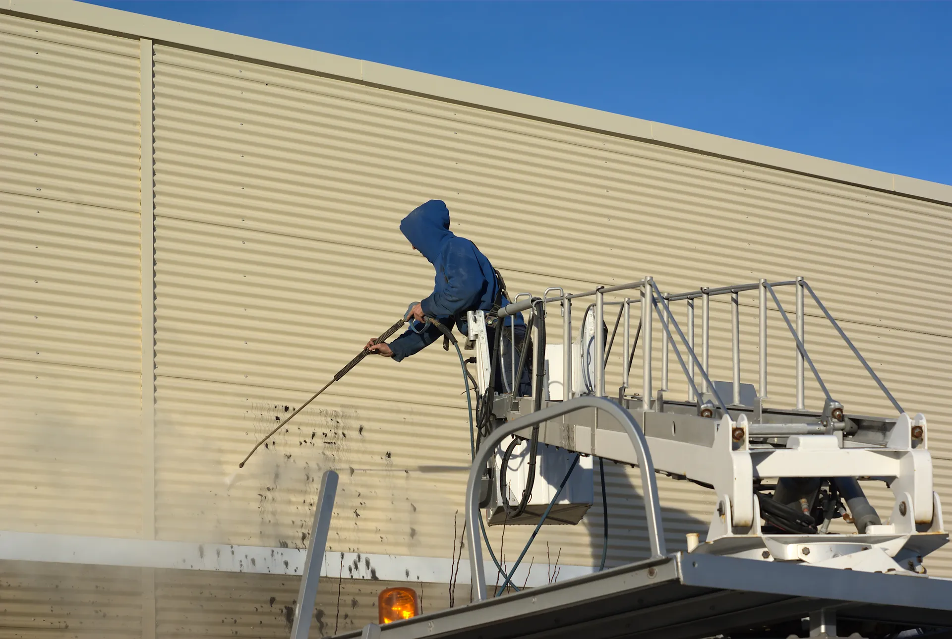 High-PSI pressure washing in progress